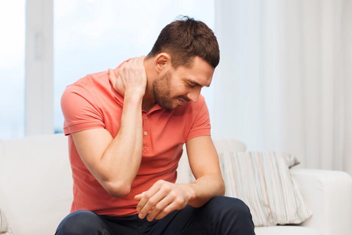 man holding his neck in pain