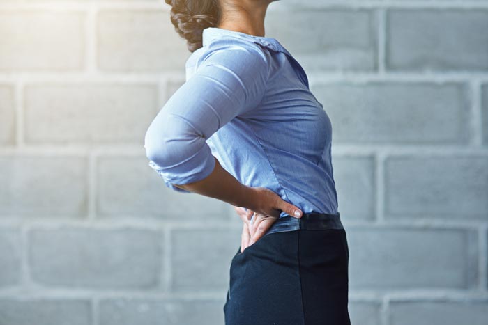 woman holding her lower back