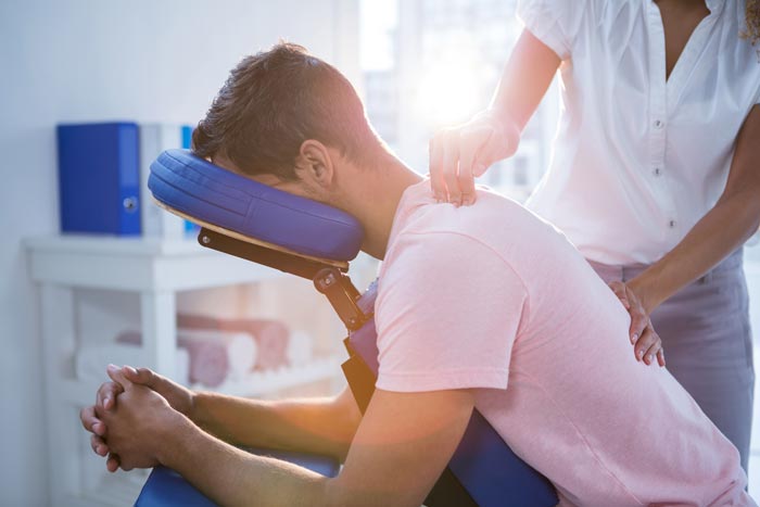 physical therapist working on man's back