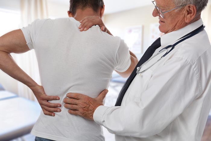 doctor examining patient's spine