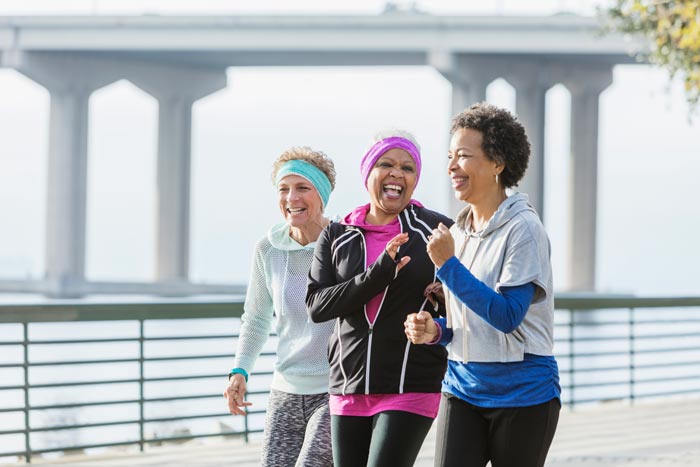 three middle aged women jogging